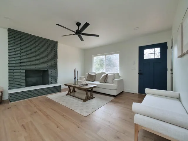 a living room with furniture and wooden floor