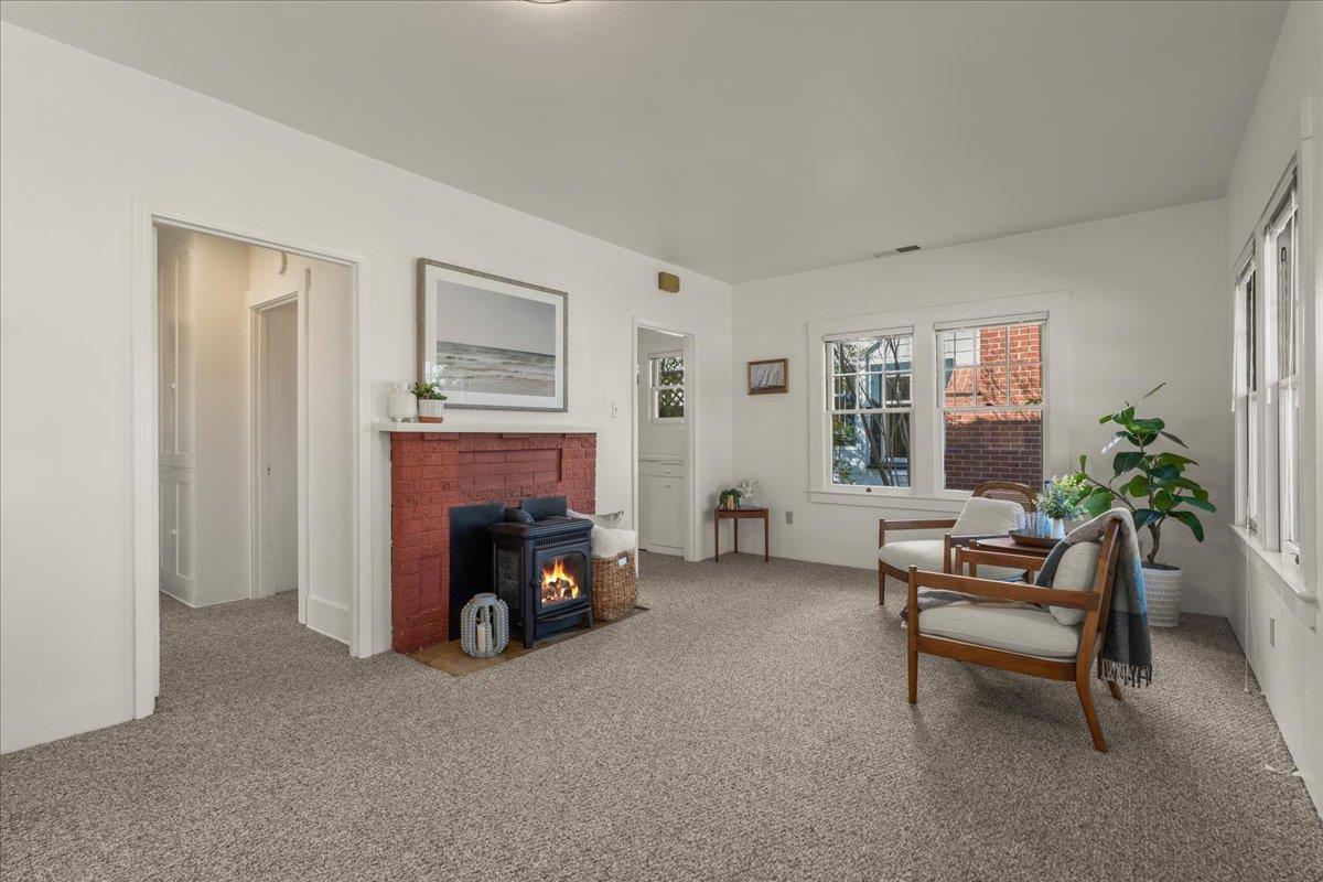 207 2nd Avenue Santa Cruz, CA 95062 - Photo 6 of 38 a living room with furniture and a fireplace