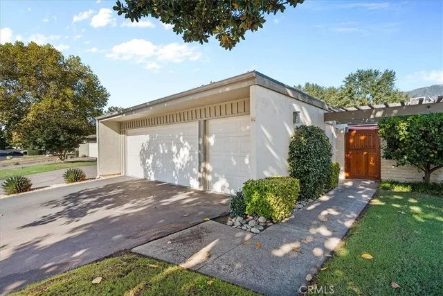 a front view of a house with a yard and a garage