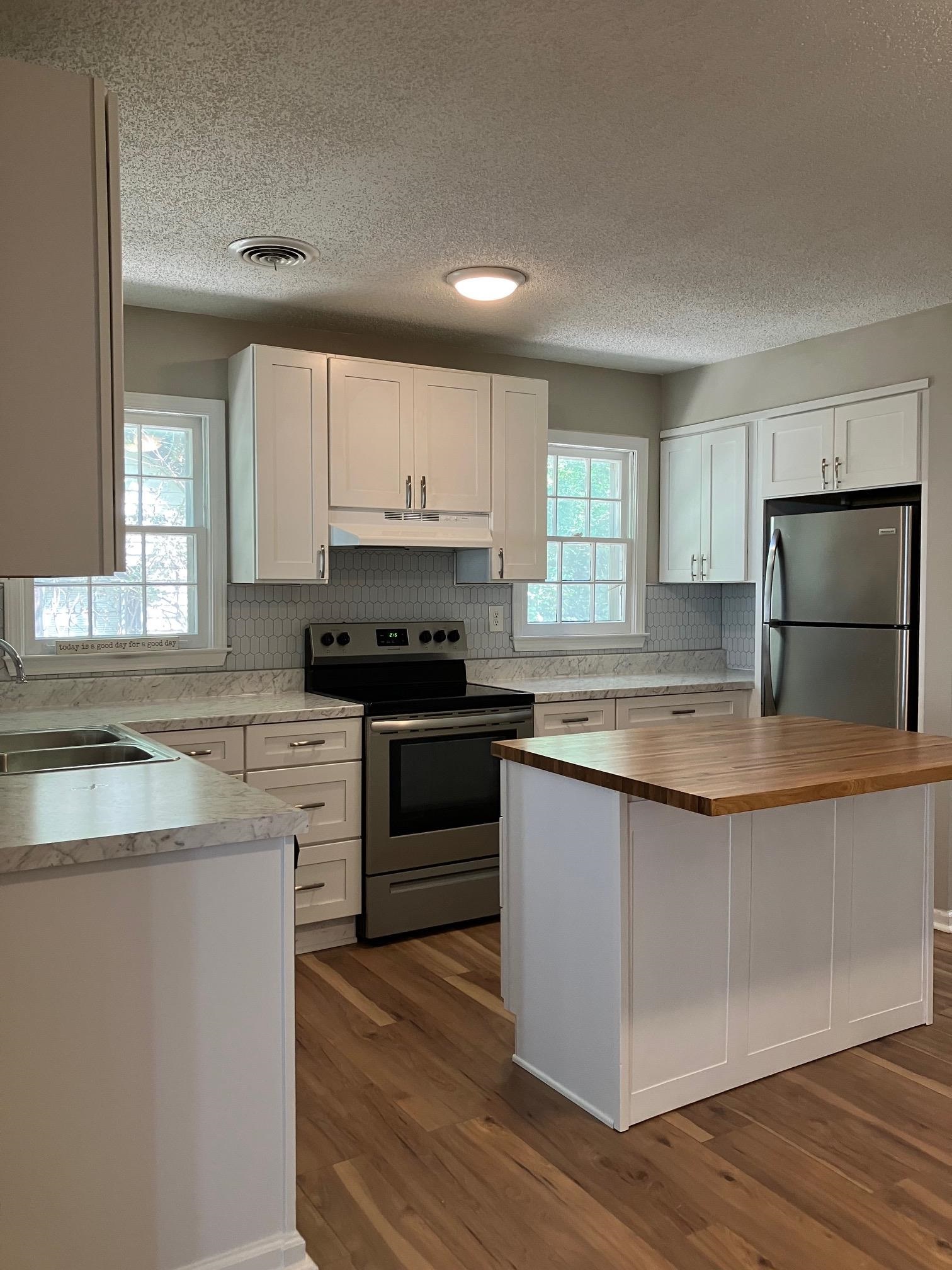3815 Vanuys Road Memphis, TN 38111 - Photo 12 of 17 a kitchen with stainless steel appliances granite countertop a stove a sink and a microwave