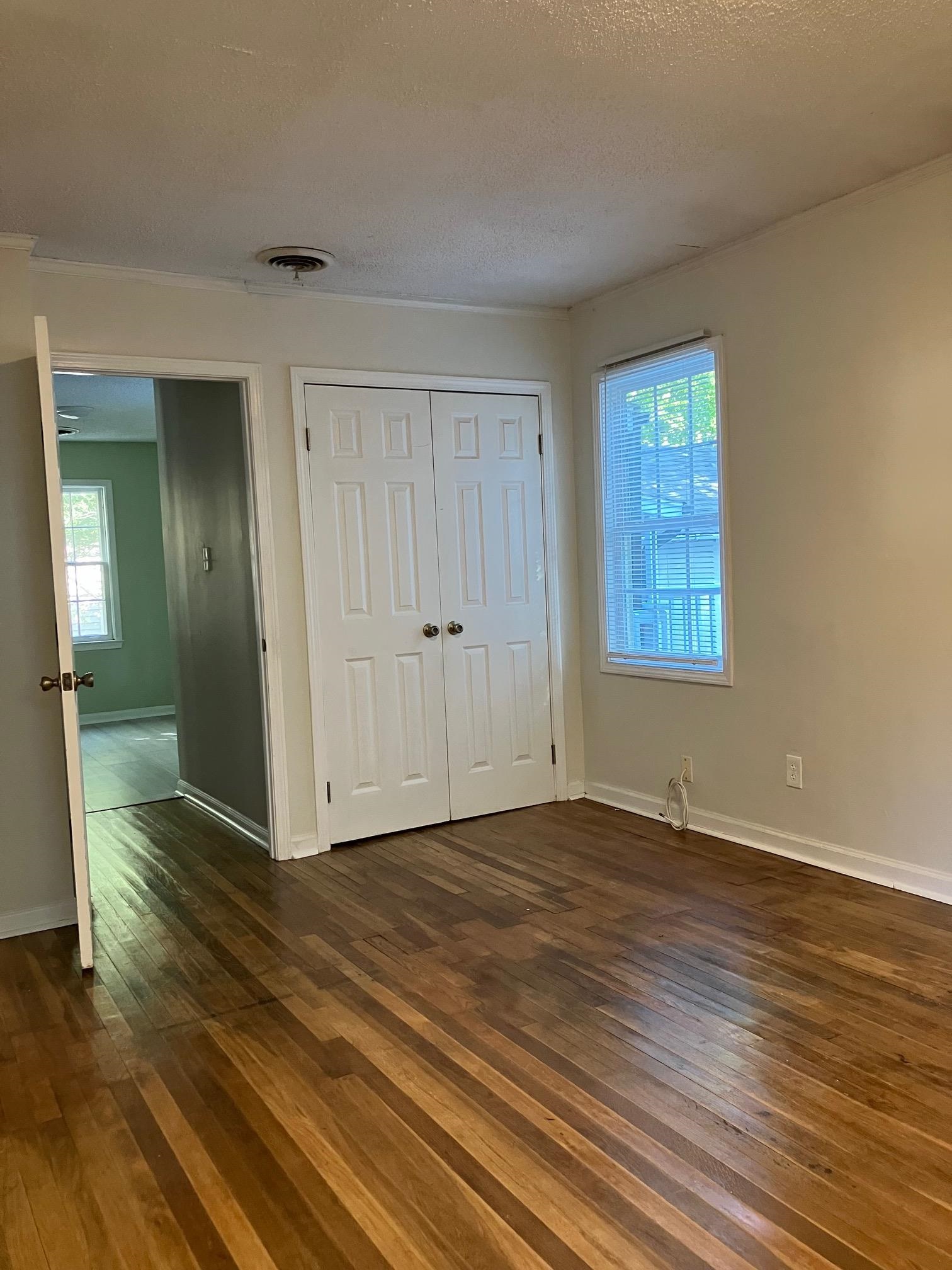 3815 Vanuys Road Memphis, TN 38111 - Photo 5 of 17 a view of an empty room with wooden floor and a window
