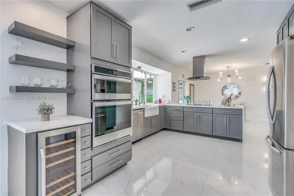 a kitchen with stainless steel appliances a refrigerator and cabinets