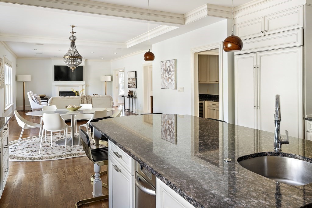17 Kesseler Way Newton, MA 02467 - Photo 15 of 33 a kitchen with stainless steel appliances granite countertop a sink dishwasher and a refrigerator with wooden floor