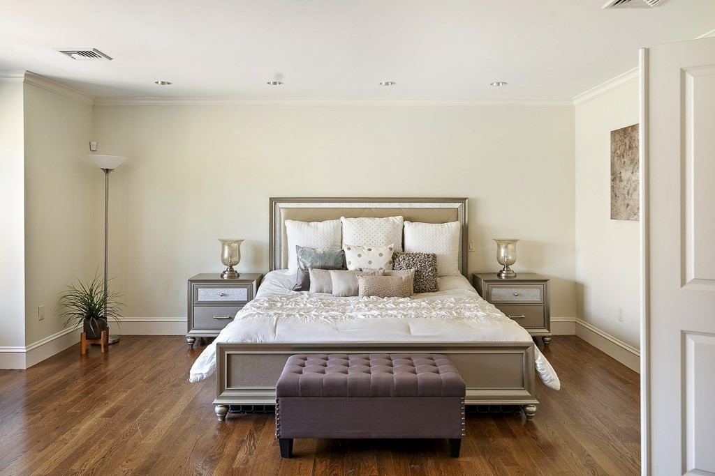 17 Kesseler Way Newton, MA 02467 - Photo 19 of 33 a bedroom with a bed and wooden floor