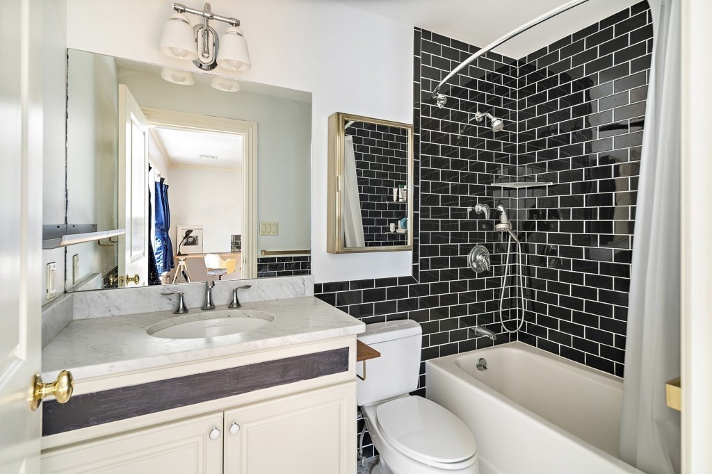 17 Kesseler Way Newton, MA 02467 - Photo 26 of 33 a bathroom with a sink toilet vanity and shower