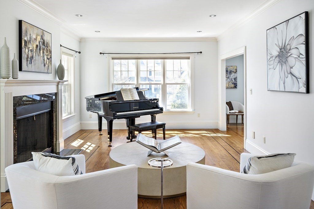 17 Kesseler Way Newton, MA 02467 - Photo 9 of 33 a living room with furniture a fireplace and a table