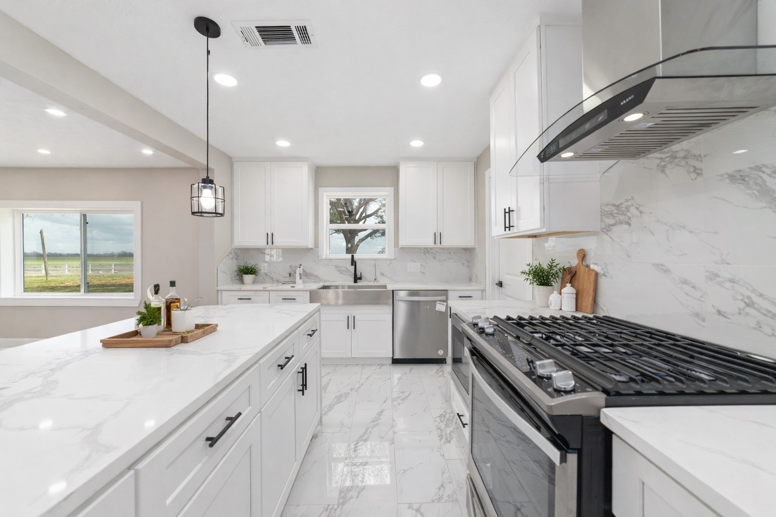 a kitchen with white cabinets and appliances