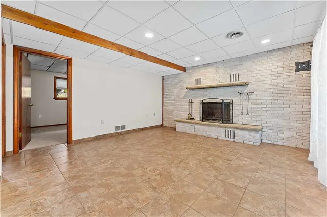 a view of an empty room with a fireplace