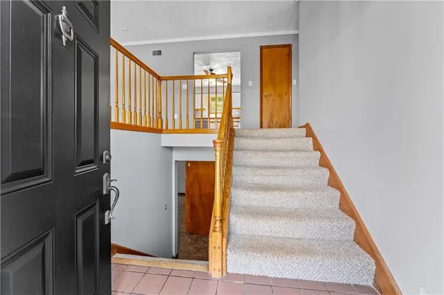 a view of entryway and hall with wooden floor