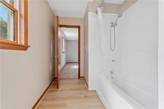 a bathroom with a bathtub and shower