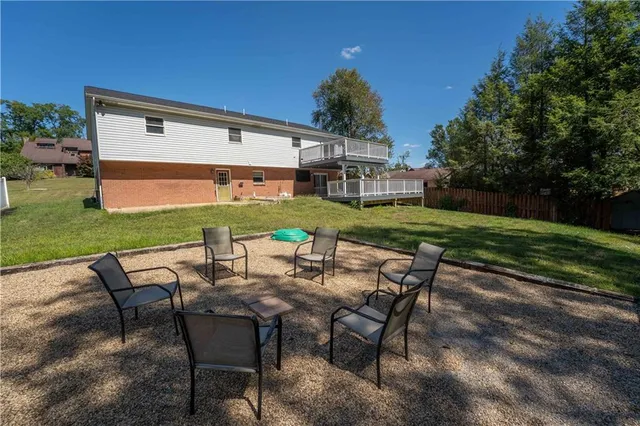 a view of a yard with furniture and garden