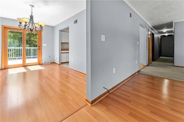 a view of a room with wooden floor