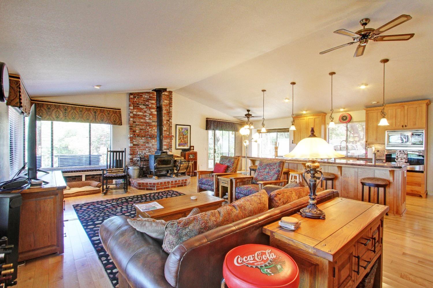 a living room with furniture a large window and chandelier