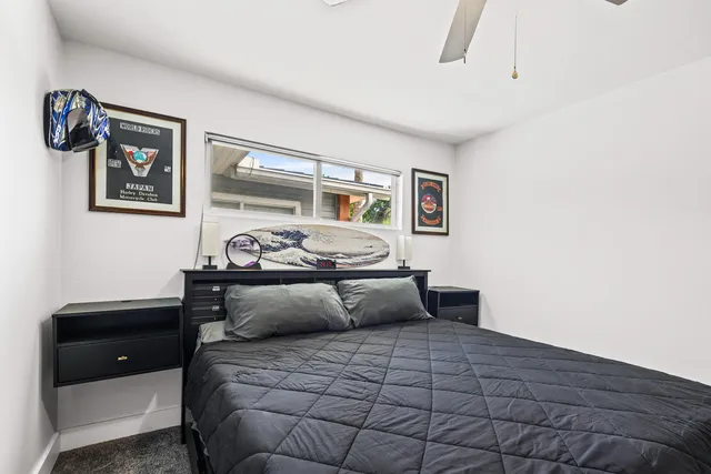 a bedroom with a bed and window