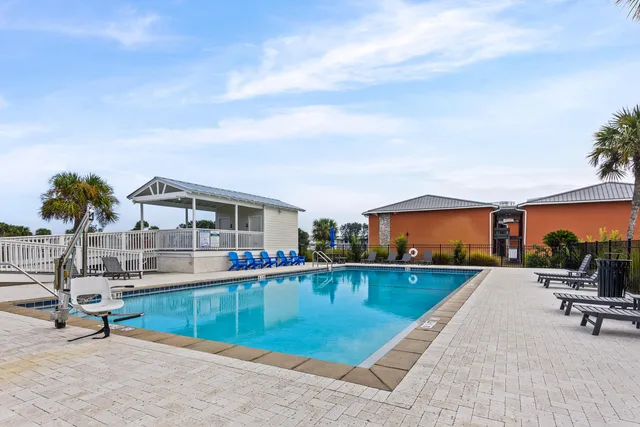 a view of a house with swimming pool and sitting area