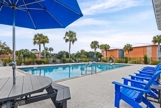 a view of a swimming pool with outdoor seating