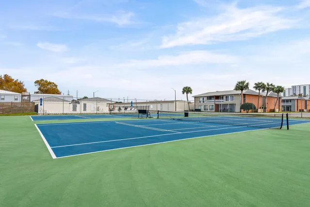 a view of green field with apartments