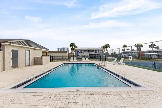 a view of a swimming pool with a lounge chair