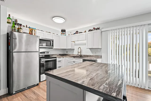 a kitchen with a refrigerator a stove top oven a sink and dishwasher