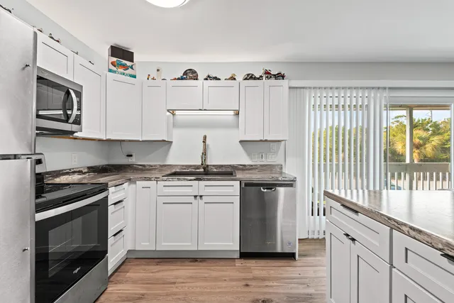 a kitchen with stainless steel appliances granite countertop a stove and a sink