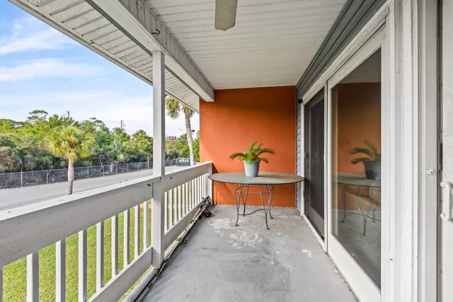 a view of a porch with wooden floor and furniture