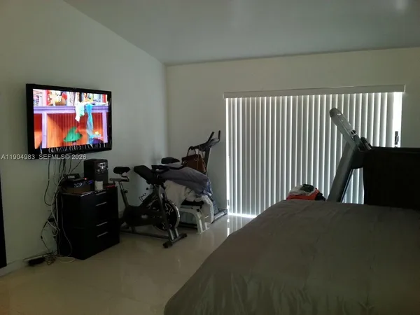 a bedroom with furniture and a flat screen tv