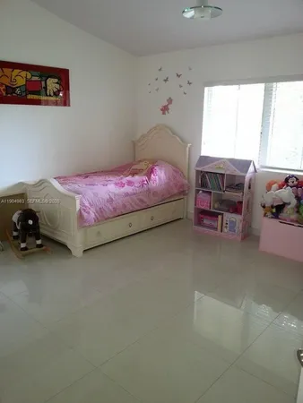 a bedroom with bed and window