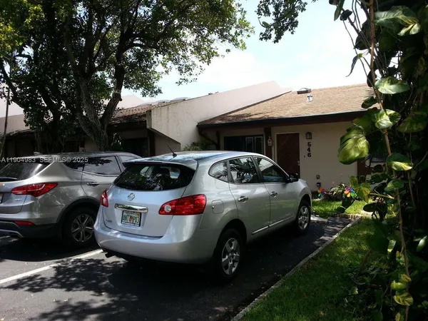 a front view of a house with parking space