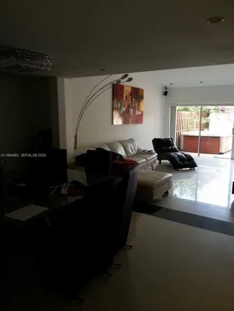 a living room with furniture window and a projector screen