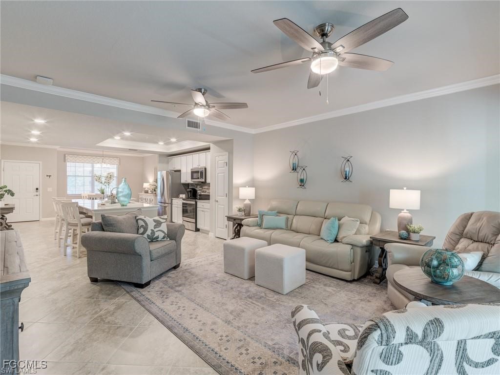 10711 Palazzo Way, Unit 203 Fort Myers, FL 33913 - Photo 2 of 24 a living room with furniture and a large window