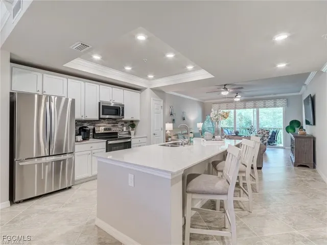 a kitchen with stainless steel appliances a refrigerator stove microwave and cabinets