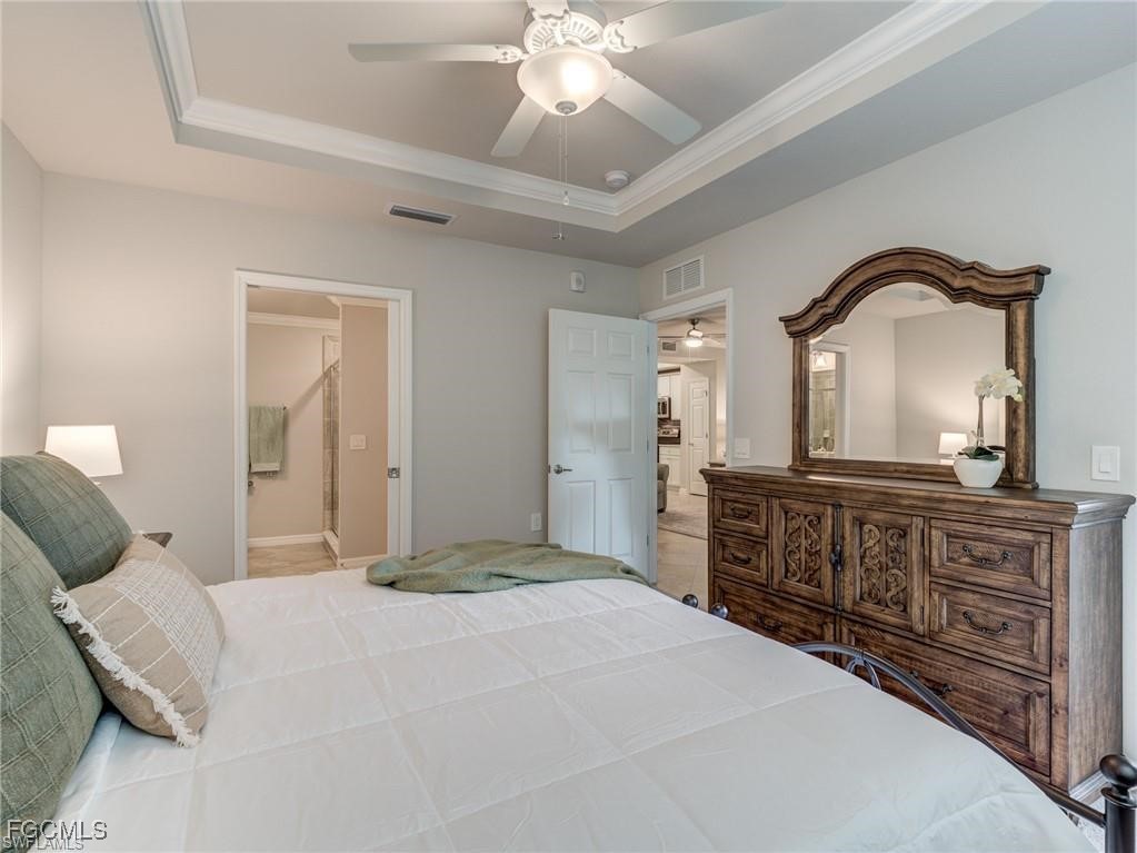 10711 Palazzo Way, Unit 203 Fort Myers, FL 33913 - Photo 8 of 24 a bedroom with a large bed and a dresser