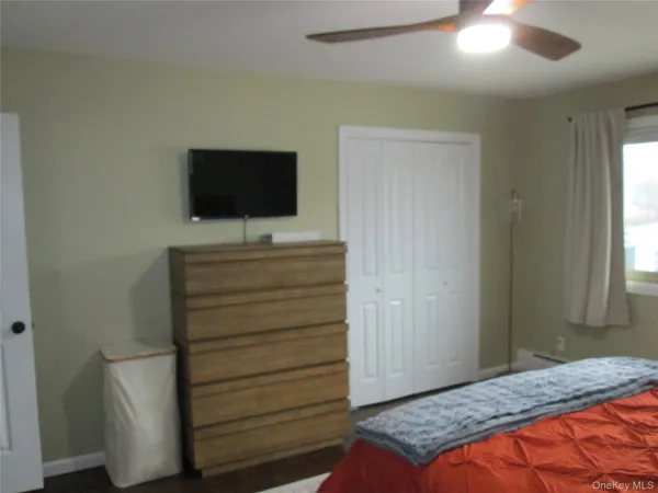 a bedroom with a bed and a television in it