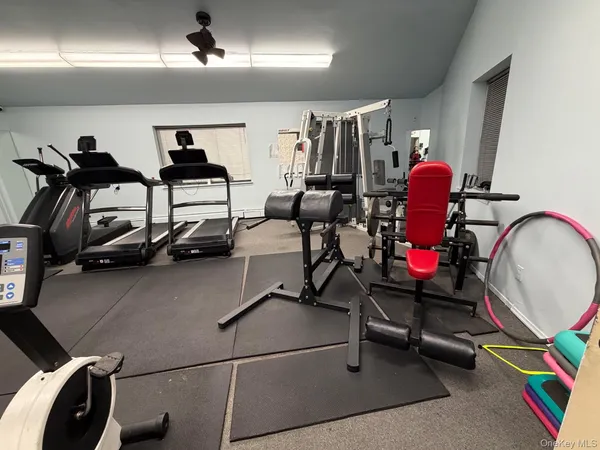 a room with gym equipment and a mirror