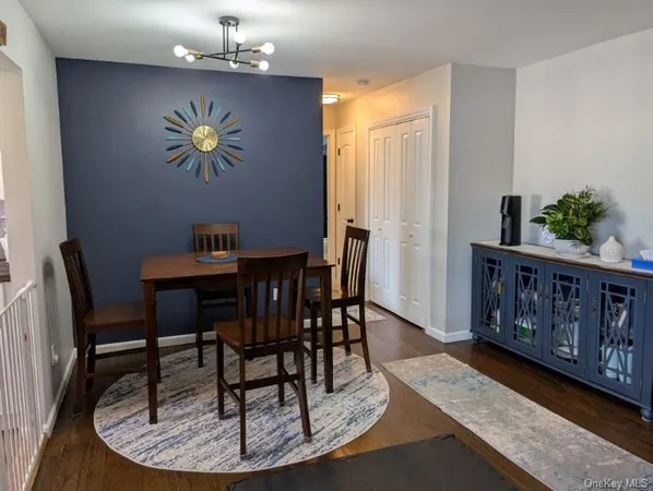 a view of a dining room with furniture a chandelier and wooden floor