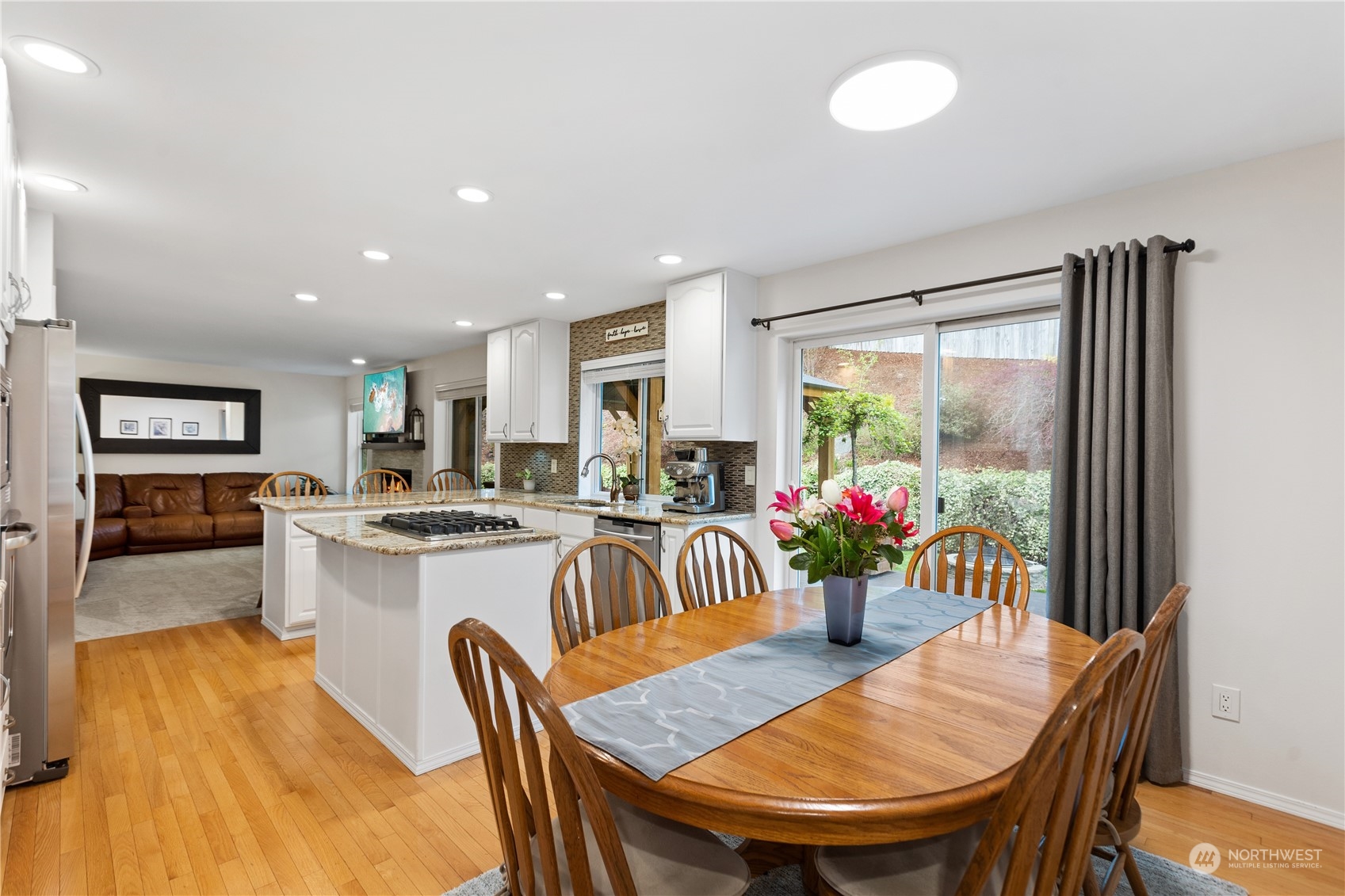 5316 152nd Place Southeast Everett, WA 98208 - Photo 11 of 37 a view of a dining room with furniture window and wooden floor