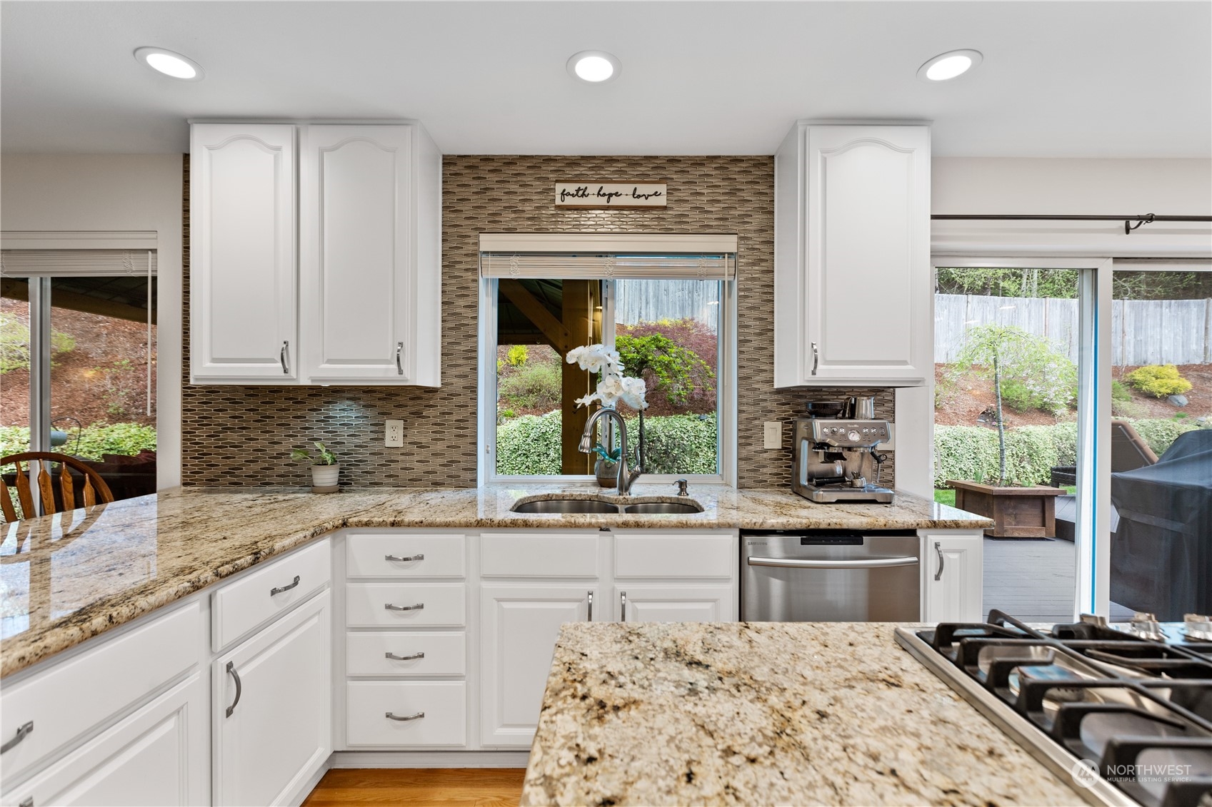 5316 152nd Place Southeast Everett, WA 98208 - Photo 14 of 37 a kitchen with stainless steel appliances kitchen island granite countertop a stove a sink and a granite counter tops with white cabinets