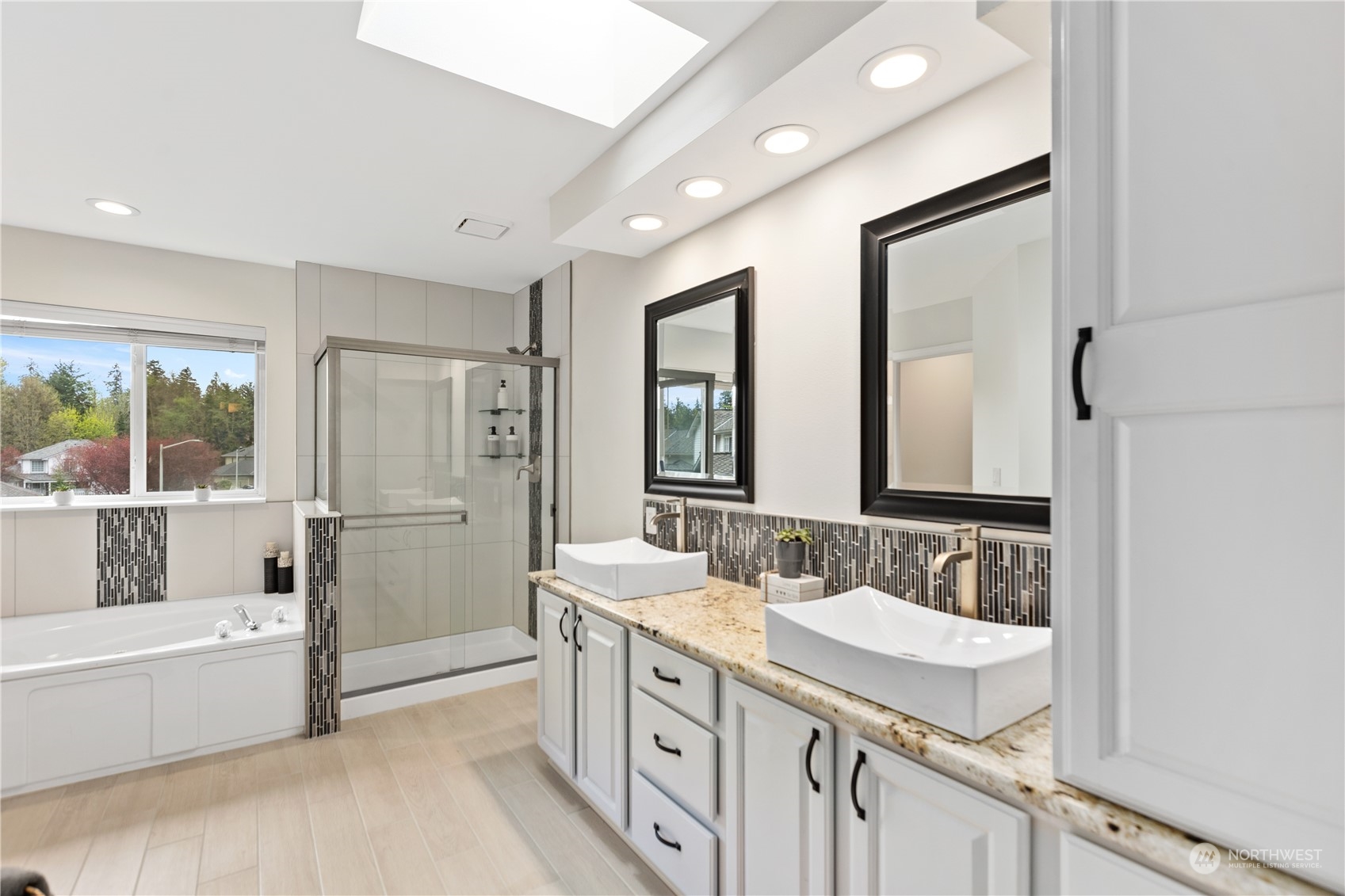 5316 152nd Place Southeast Everett, WA 98208 - Photo 30 of 37 a spacious bathroom with a granite countertop tub sink a mirror a vanity and next to a window