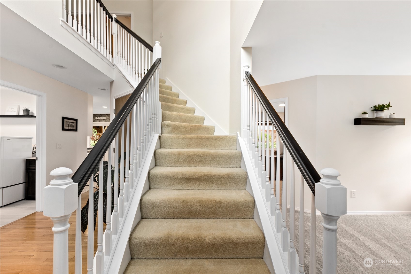 5316 152nd Place Southeast Everett, WA 98208 - Photo 4 of 37 a view of staircase with lots of frames on wall and windows
