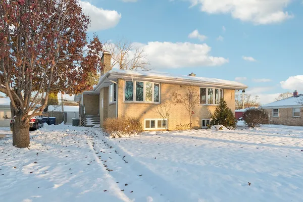 a view of a house with a snow in the yard