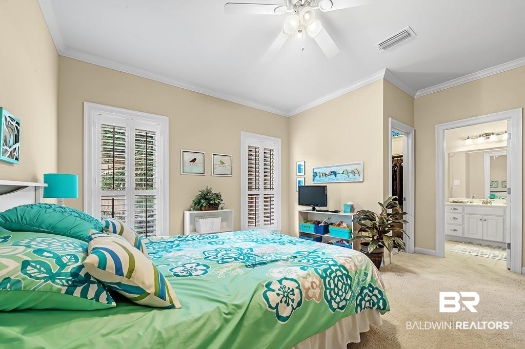 29976 Dolive Ridge Daphne, AL 36527 - Photo 37 of 58 Carpeted bedroom with ornamental molding, ensuite bathroom, ceiling fan, and a closet