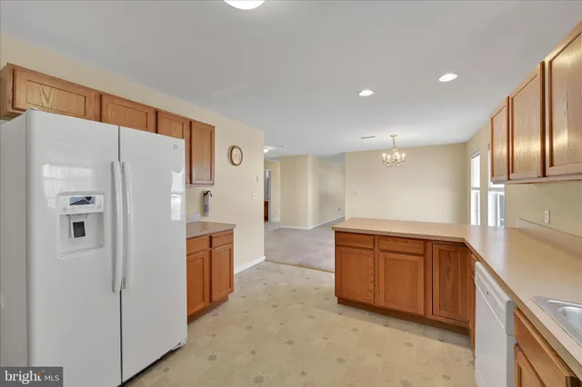 a kitchen with stainless steel appliances a refrigerator and a sink