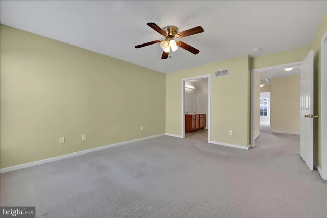 a view of an empty room with a ceiling fan