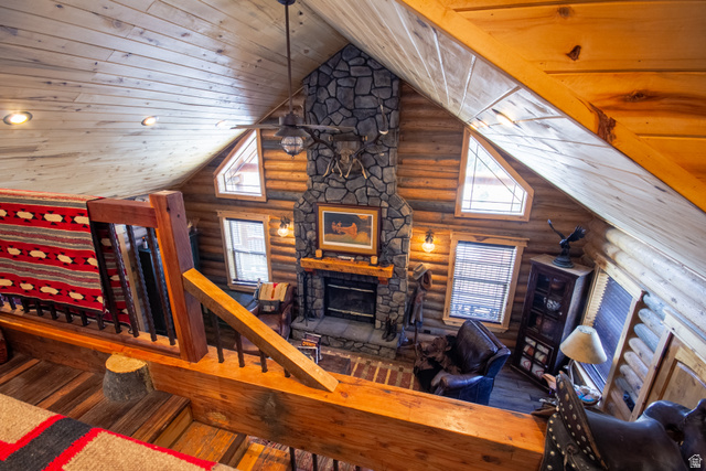 18906 North Canyon Road Whiterocks, UT 84085 - Photo 34 of 65 Living room featuring wood-type flooring, log walls, a fireplace, wood ceiling, and high vaulted ceiling