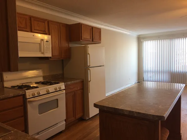 a kitchen with a stove a sink and a microwave