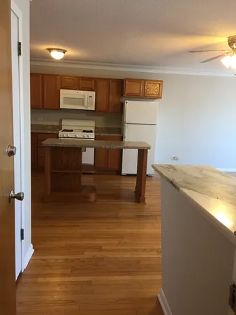 a bathroom with a sink and a refrigerator