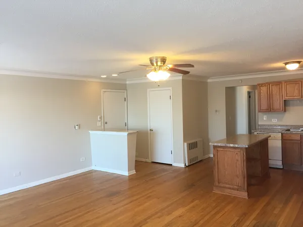 a view of a kitchen with furniture and wooden floor