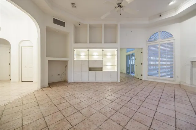 a view of an empty room with window and fireplace