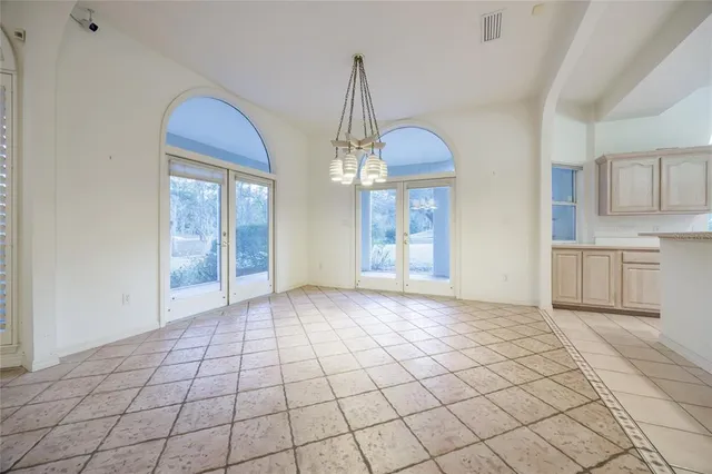 a kitchen with stainless steel appliances a sink a stove a refrigerator cabinets and living room view