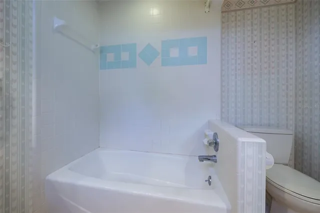 a utility room with cabinets washer and dryer